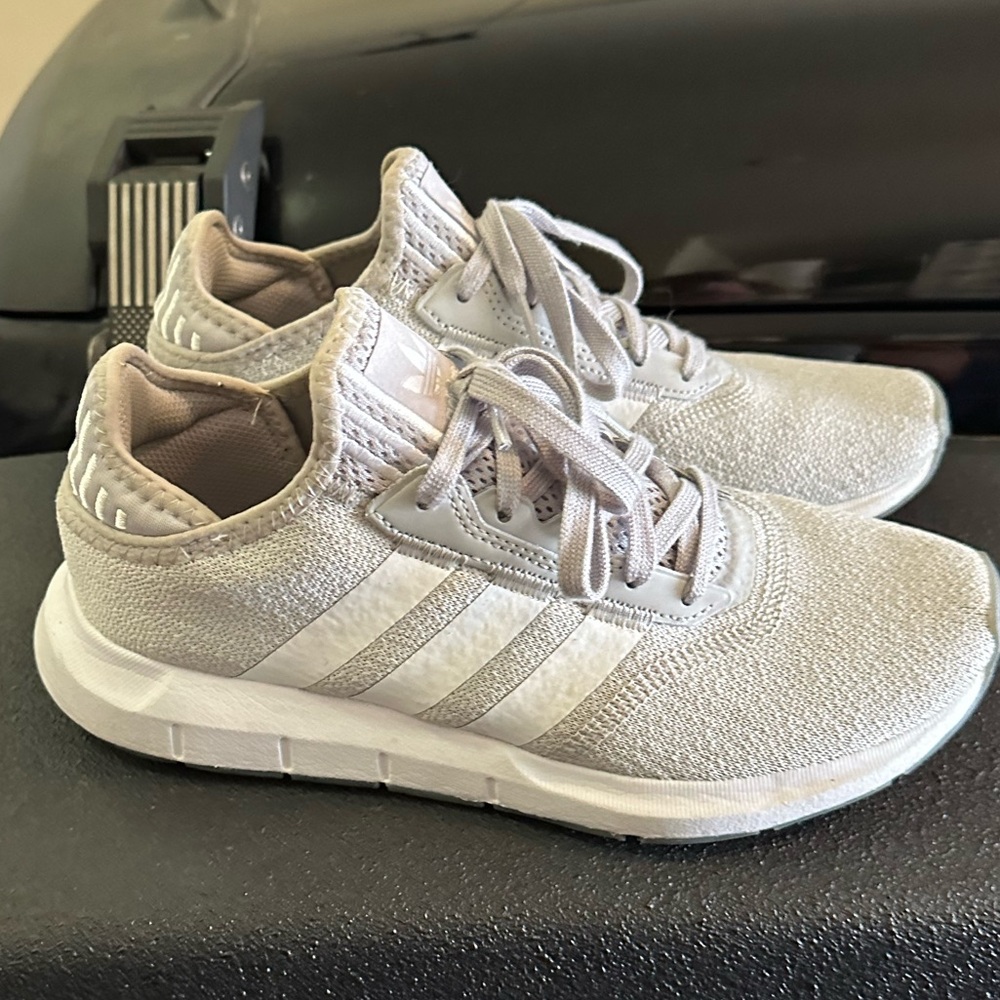 Grey and white Adidas tennis shoes
